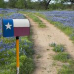 A Mailbox, a Texas Flag, and bluebonnets in the Hill Country